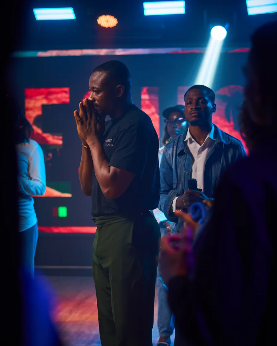 Richard Michael standing in prayer, hands together, during a ministration